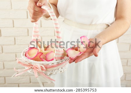 Girl holding  basket of flowers. Wedding concept