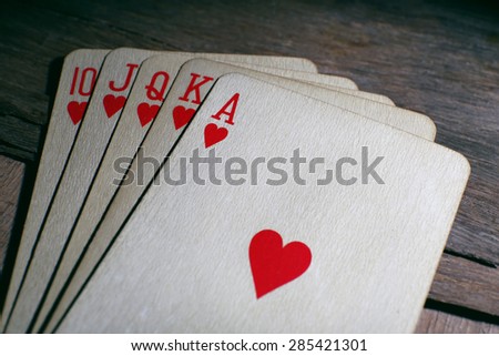 Playing cards on wooden table, closeup