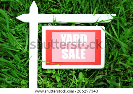 Wooden Yard Sale sign over green grass background