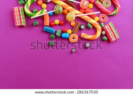 Colorful candies on purple background