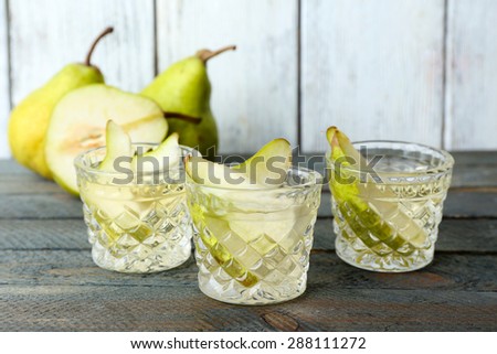 Pear juice with fresh fruits on wooden background