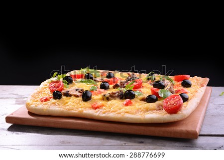 Delicious homemade pizza on table on black background
