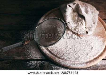 White flour on cutting board on wooden table background