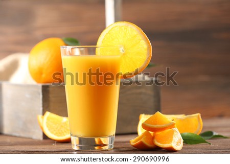Orange juice on table on wooden background