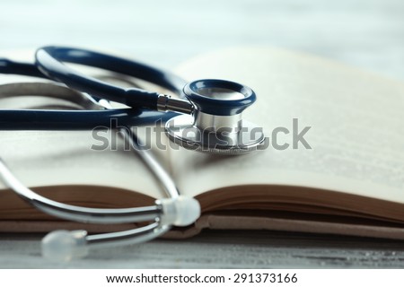 Stethoscope on open book close up