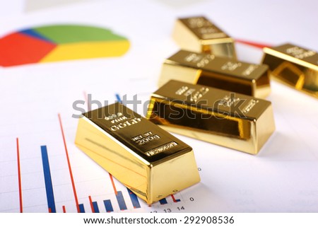 Gold bullion on documents background