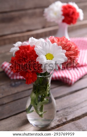 Beautiful flowers in vases on table close up