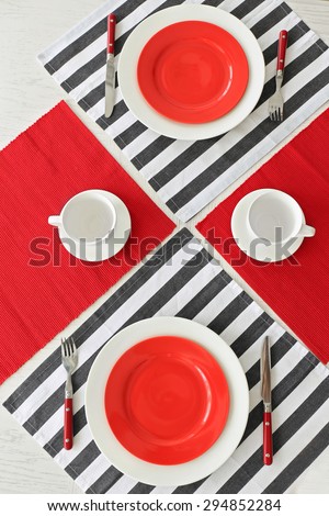 Table setting with red and striped napkins