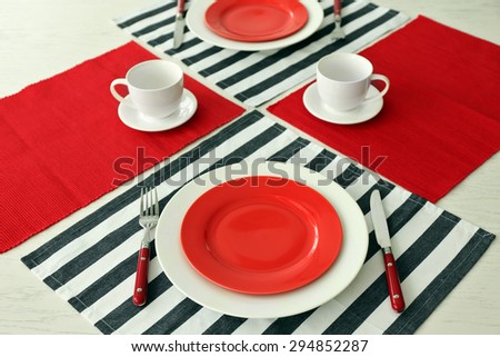 Table setting with red and striped napkins