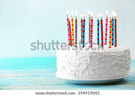 Birthday cake with candles on light background