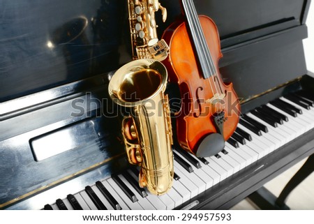 Violin and saxophone on piano background