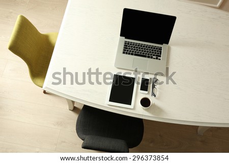 Laptop with tablet and smart phone on Workplace top view