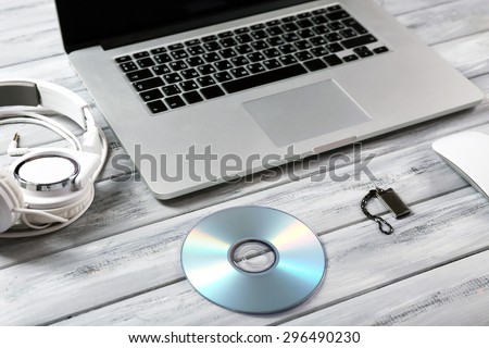 Workplace with laptop and other computer accessories on wooden table, closeup