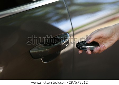 Hand presses on remote control car alarm systems