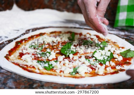 Preparing pizza on marble table, closeup