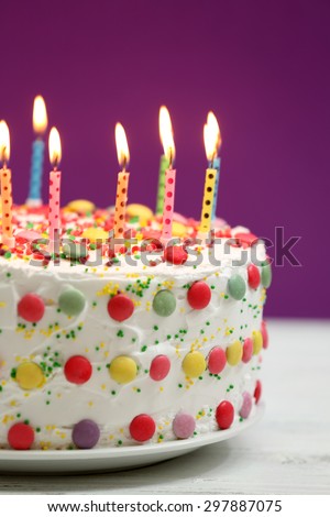 Birthday cake with candles on purple background