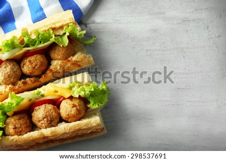Homemade Spicy Meatball Sub Sandwich on wooden table background