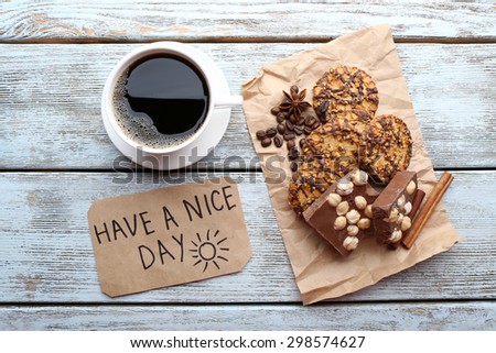 Cup of coffee with fresh croissant and Have A Nice Day massage on wooden table, top view