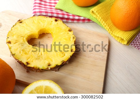 Pineapple slice with cut in shape of heart on table close up