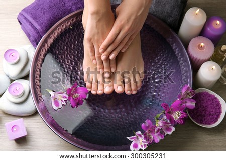 Female feet at spa pedicure procedure