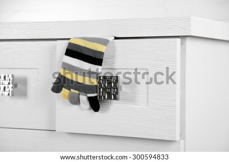 White wooden chest of drawer with sock in opened drawer