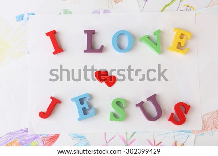 I LOVE JESUS sign illustrated with colorful plastic letters on drawings background