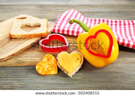 Salad pepper with cut in shape of heart and cheese on table close up