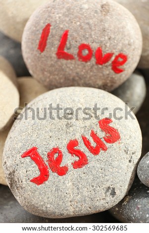 Pebbles with inscription I LOVE JESUS, closeup