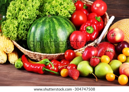 Composition with fresh fruits and vegetables on wooden table, closeup