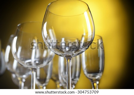 Empty wine glasses on yellow background