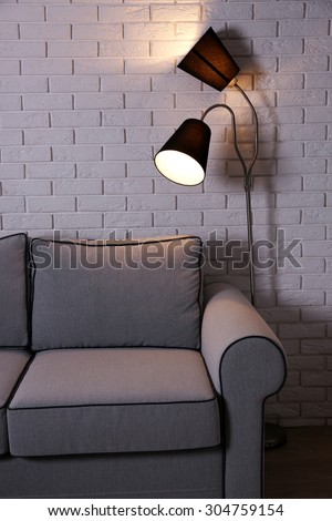 Beautiful modern living room with grey sofa and floor lamp