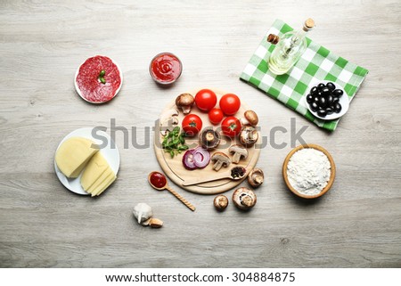 Ingredients for cooking pizza on wooden table, top view