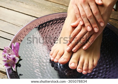 Female feet at spa pedicure procedure
