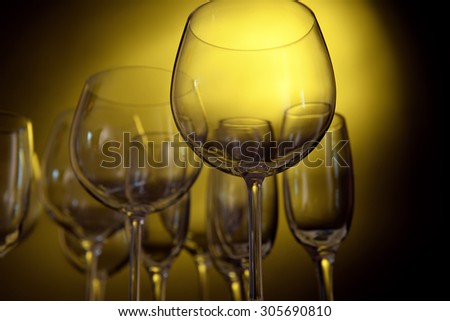 Empty wine glasses on yellow background