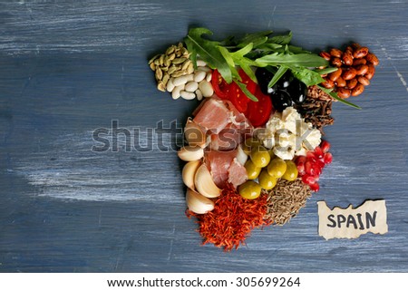 Map of Spain made with ingredients of traditional Spanish cuisine on color wooden background