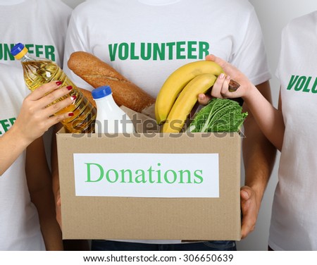 Volunteer holding donation box with food, closeup