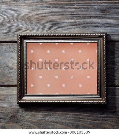 Old frame on wooden background