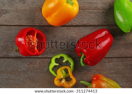 Colorful peppers on rustic wooden table, top view