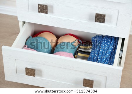 Underwear in wooden chest of drawer, close up