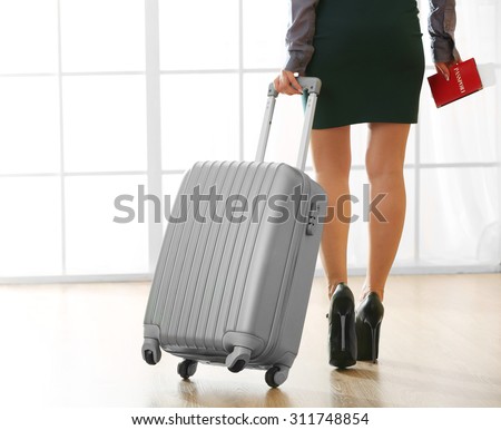 Woman with suitcase in hall