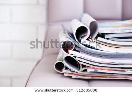Stack of magazines on chair, close up