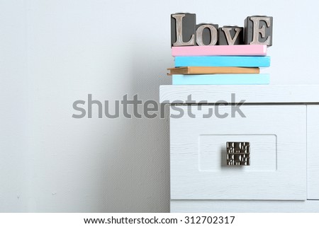 Books with word Love on wall background