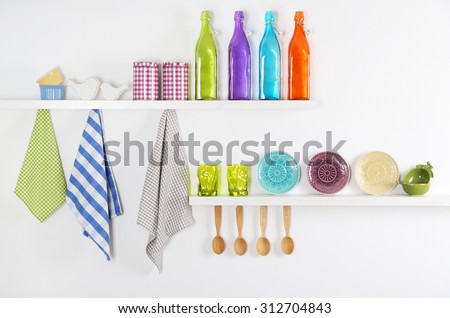 Kitchen utensils on wooden shelves, close up