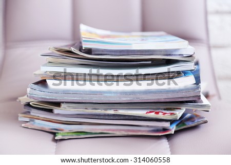 Stack of magazines on chair, close up