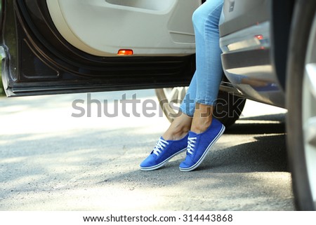 Woman with sporty legs in car, close-up