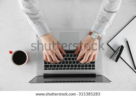 Man working with laptop, top view