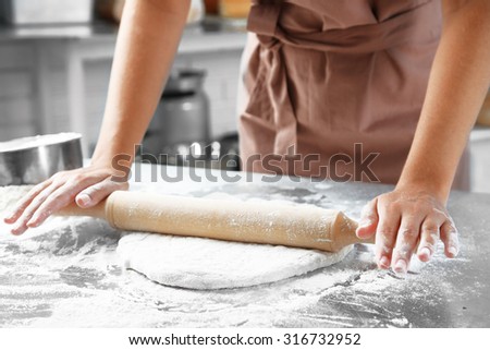 Making dough by female hands at bakery