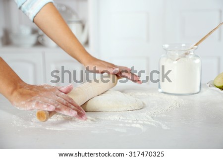 Making dough  for apple pie by female hands at kitchen