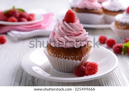 Delicious cupcake with berries on table close up