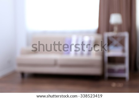 Pastel color room interior with comfortable sofa and pillows, blurred